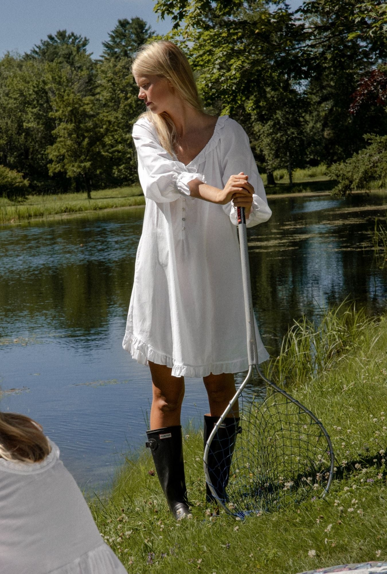A lady wearing white cotton poet nightshirt with divine pattern.
