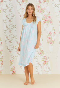 A lady wearing aqua sleeveless waltz knit nightgown with tencel hibiscus grove print.