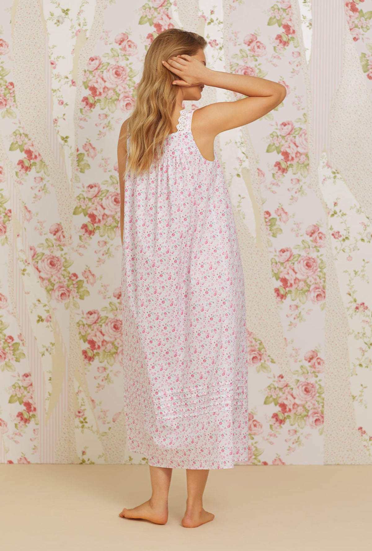 A lady wearing pink sleeveless elizabeth cotton woven nightgown with secret garden print.