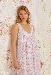 A lady wearing pink sleeveless elizabeth cotton woven nightgown with secret garden print.