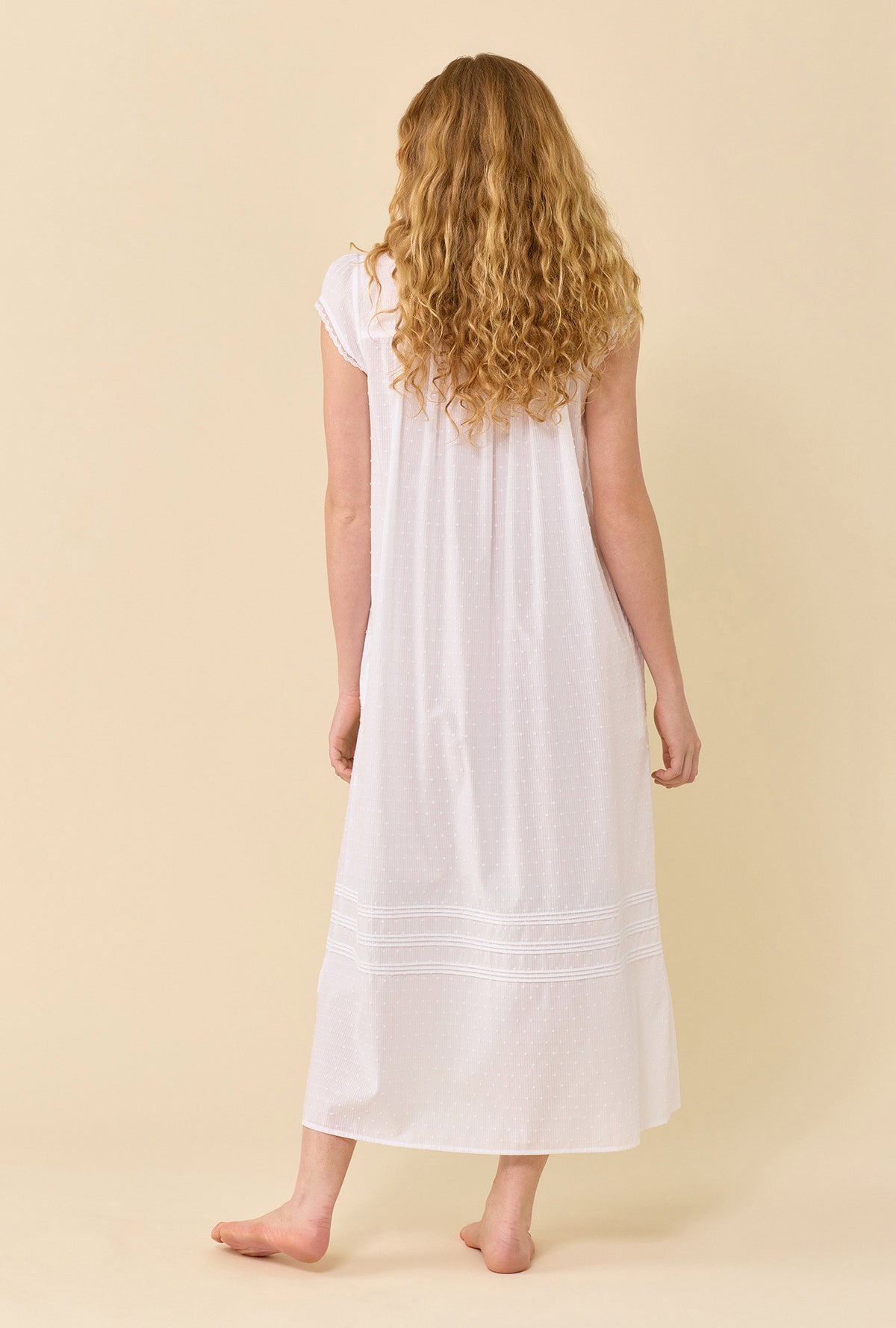 A lady wearing Swiss Dot Robe soft white  back view