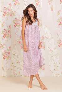 A lady wearing sleeveless eileen cotton lawn nightgown with rose jubilee print.