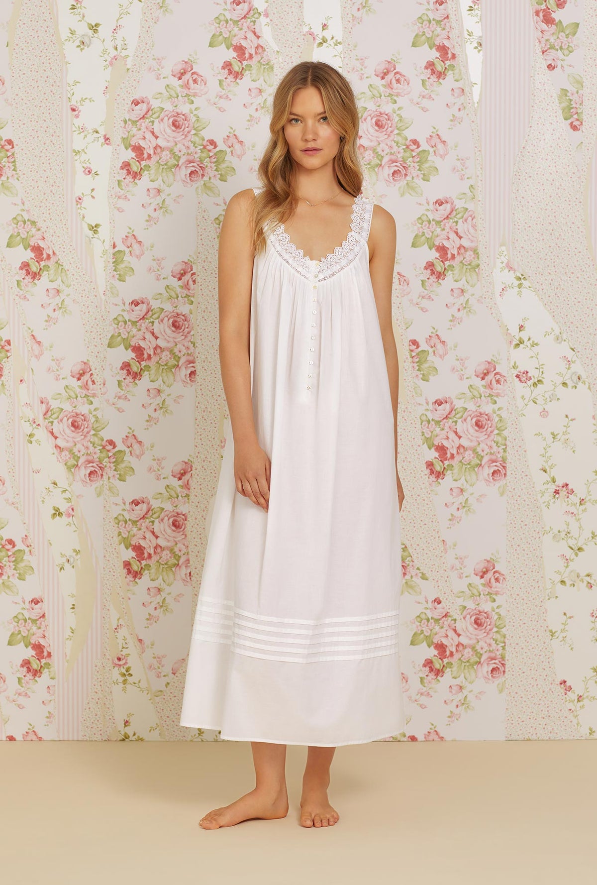 A lady wearing white sleeveless elizabeth cotton woven nightgown.