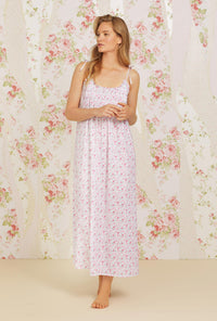 A lady wearing pink sleeveless erica cotton nightgown with secret garden print.