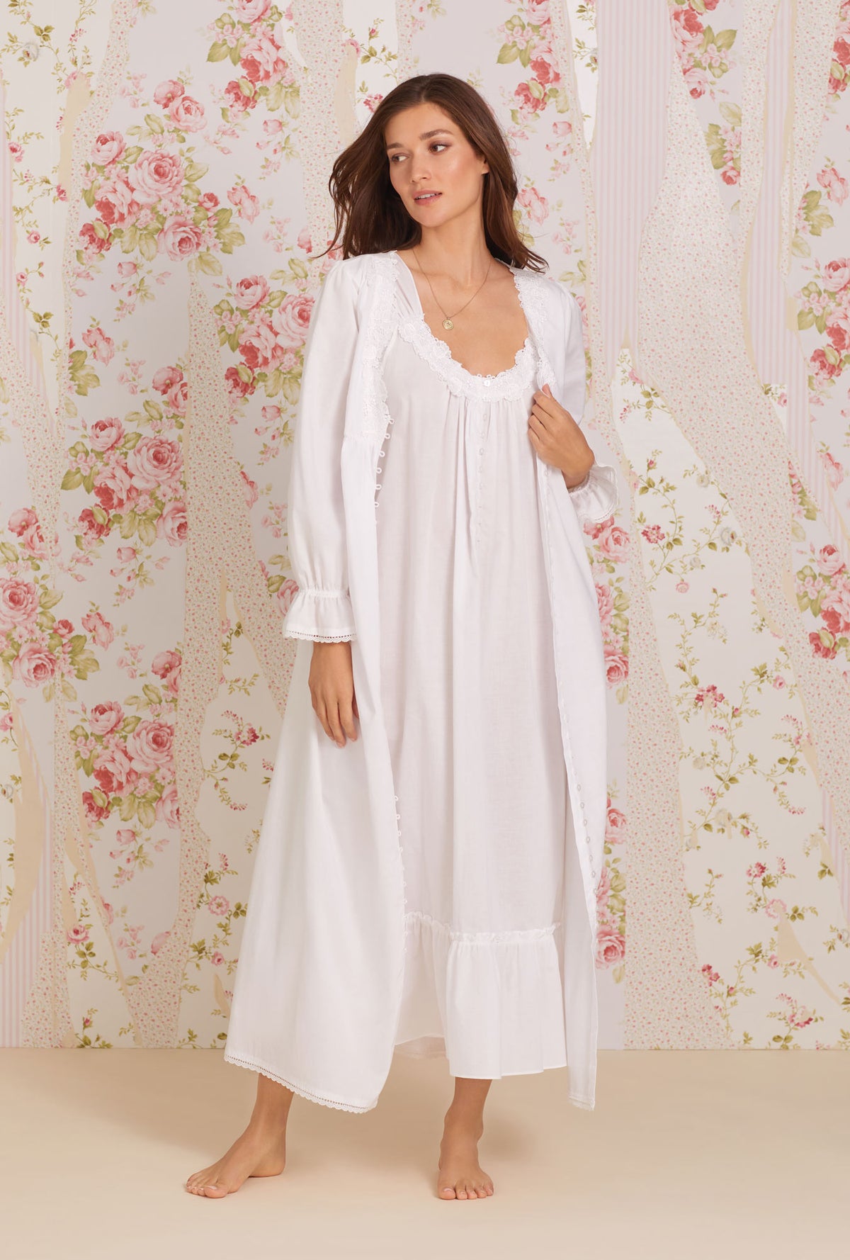 A lady wearing white cap sleeve tabitha calla lily cotton nightgown.