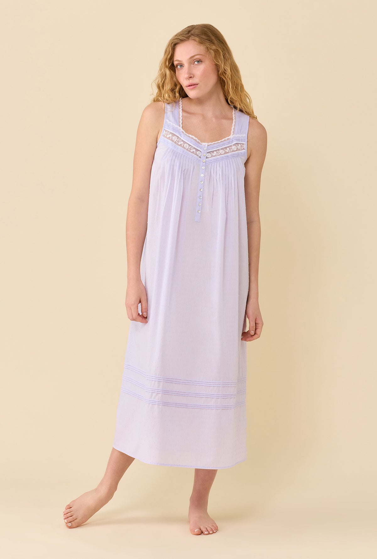 A Lady Wearing Wild Lavender The Eileen Swiss Dot Nightgown in a front view pose with one leg slightly lifted up