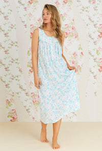 A lady wearing white and aqua sleeveless eileen knit nightgown with primrose garden print.