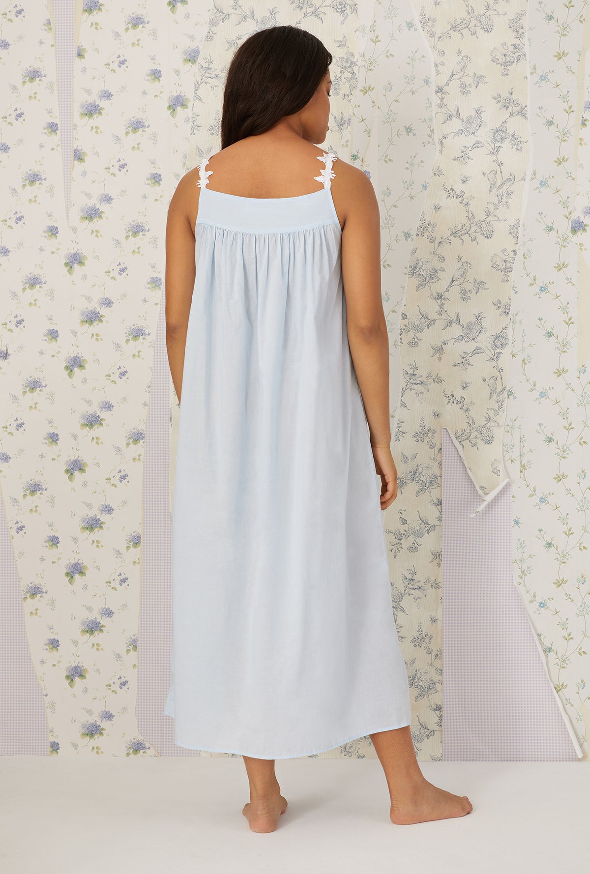 A lady wearing plus size light blue Florentine Lace Ballet Gown in a back view pose