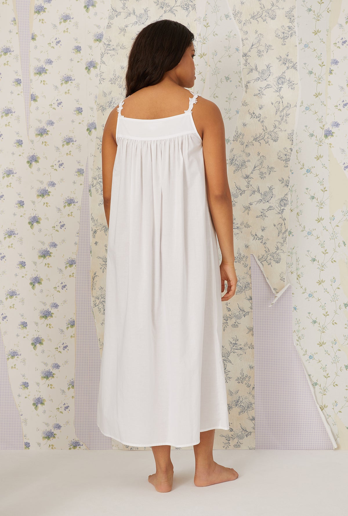 A lady wearing plus size white Florentine Lace Ballet Gown in a back view pose