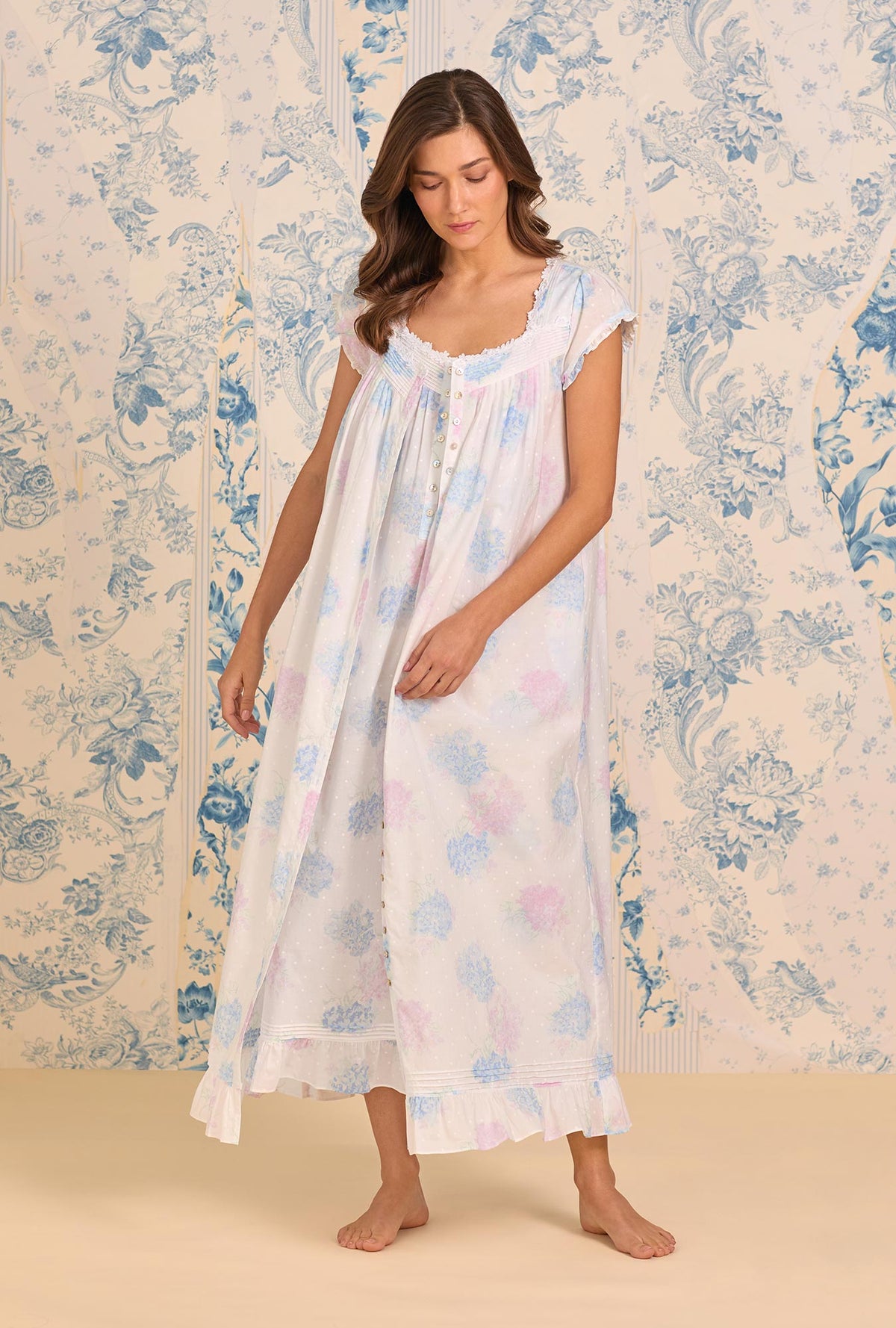 A lady wearing Hydrangea Blossom Cotton Lawn Button Front Robe looking down