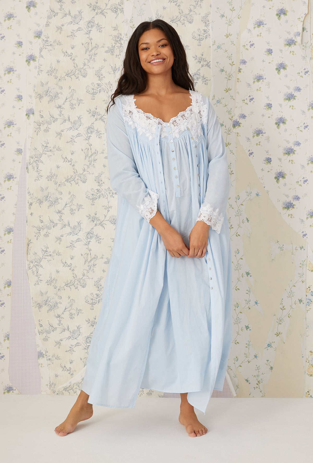 A lady wearing plus size light blue Florentine Lace Ballet Robe in a front facing view with a smile