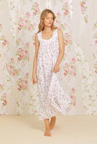 A lady wearing pink sleeveless eileen cotton nightgown with swiss dot jubilee floral print.