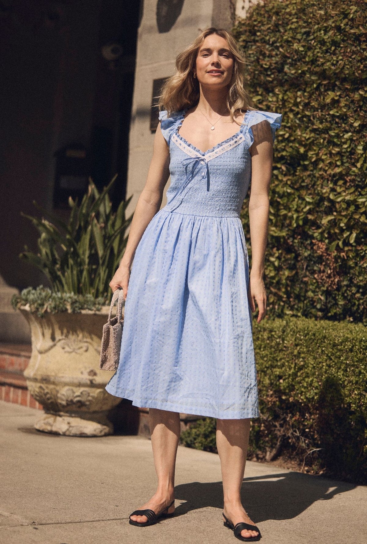 A lady wearing The "Ada" Bluebell Peri Cotton Swiss Dot Midi Dress 