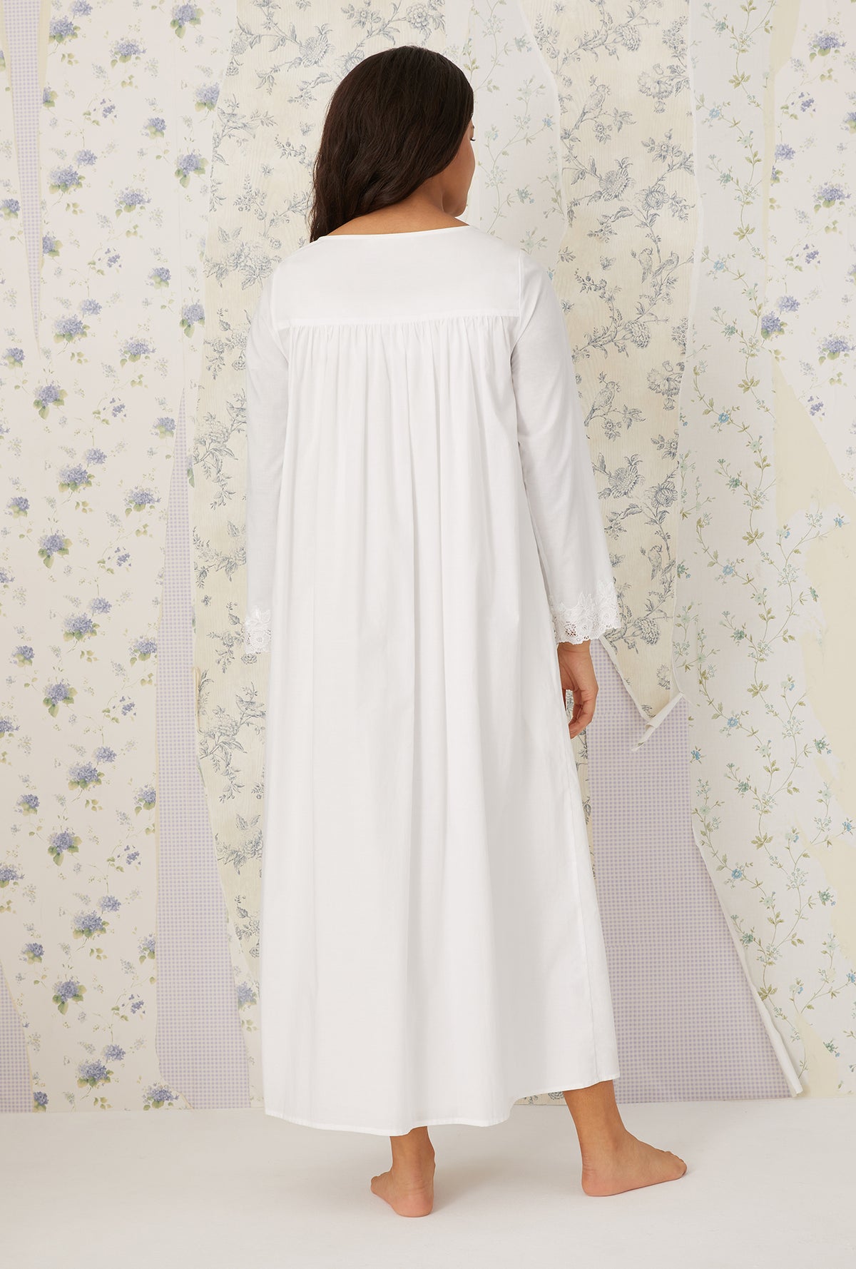 A lady wearing plus size white Florentine Lace Ballet Robe in a back view pose