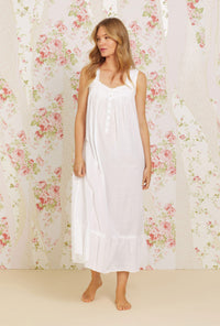 A lady wearing white sleeveless swiss dot eileen cotton nightgown.
