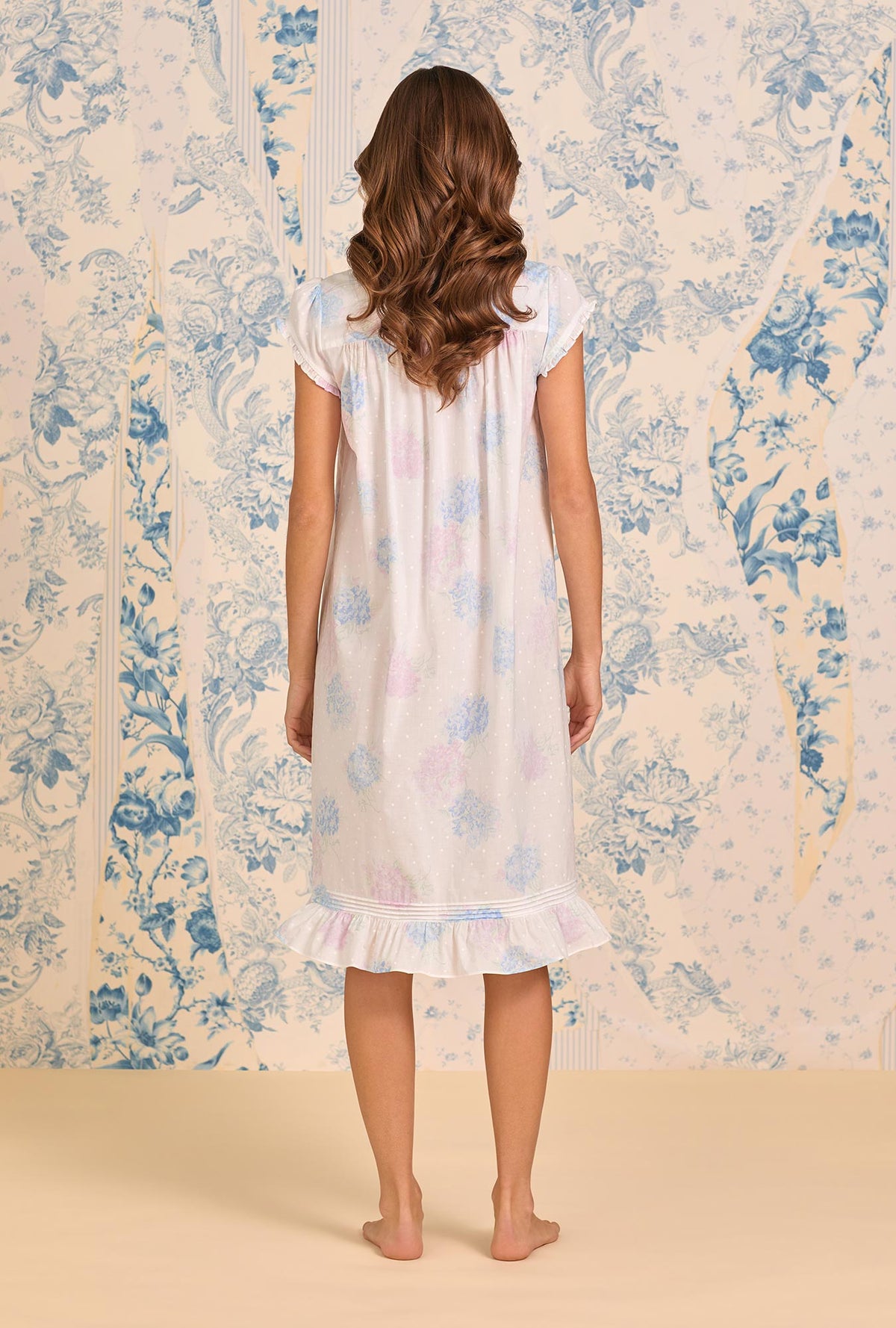 A lady wearing Hydrangea Blossom Cotton Lawn Cap Sleeve Waltz Nightgown back view
