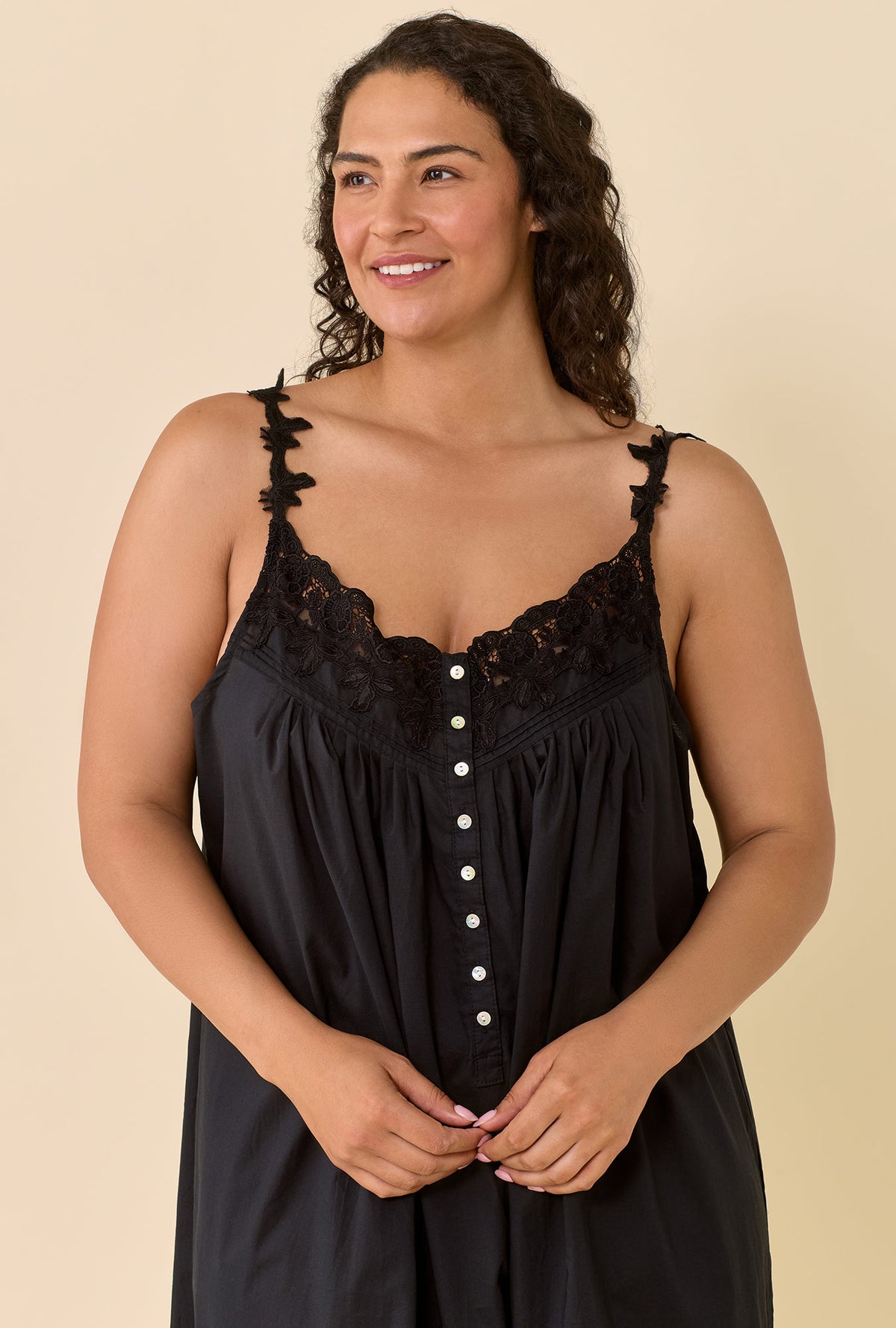 A lady wearing plus size black Florentine Lace Ballet Gown in a half close up shot