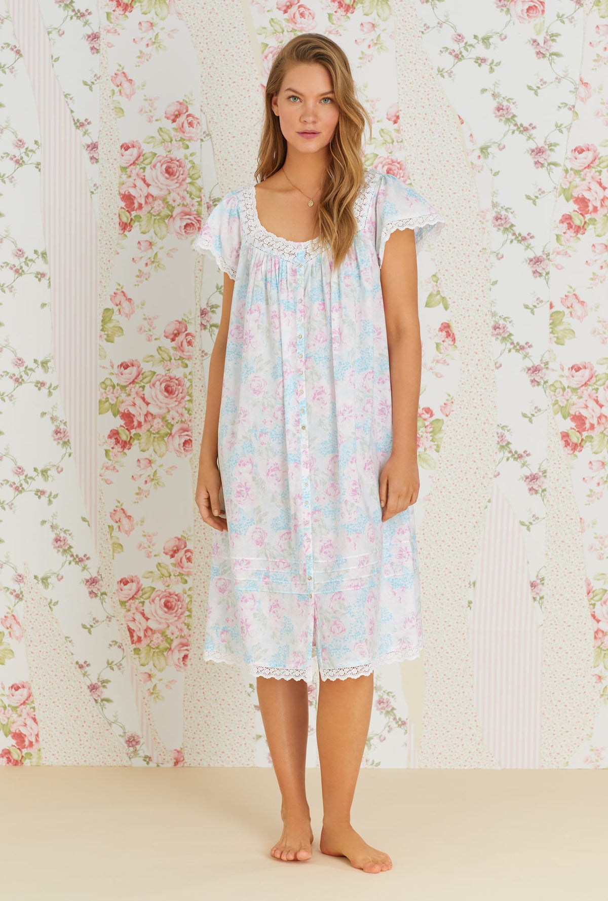 A lady wearing multi color cap sleeve esme waltz nightgown with monterey bay print.