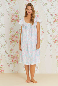 A lady wearing multi color cap sleeve esme waltz nightgown with monterey bay print.