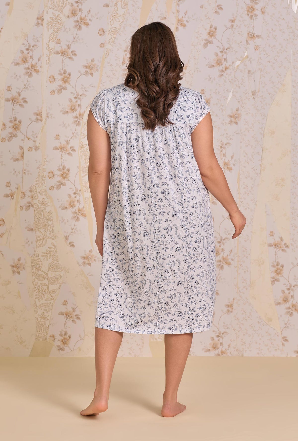 A lady wearing plus size Heritage Rose Cotton Modal Cap Sleeve Waltz Nightgown back view