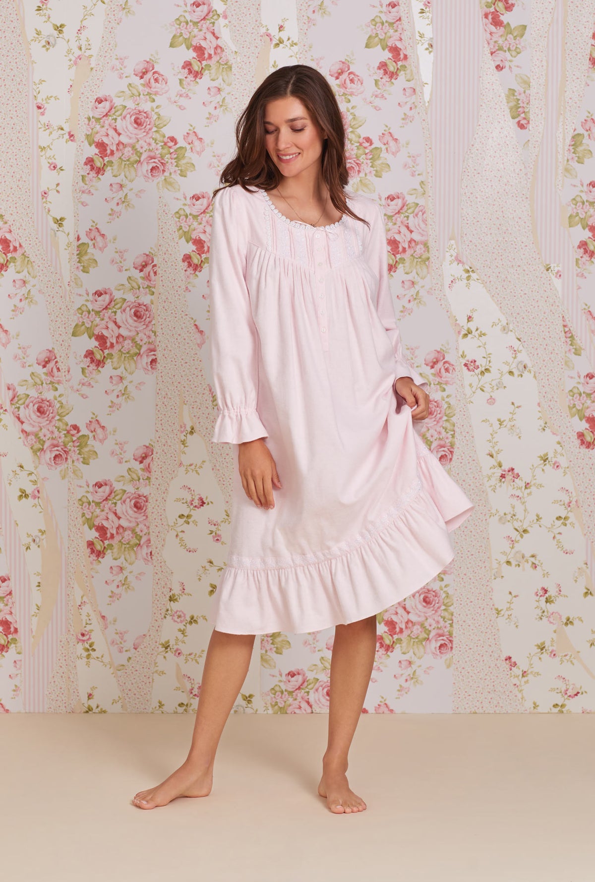A lady wearing pink long sleeve heritage cotton flannel embroidery waltz nightgown.