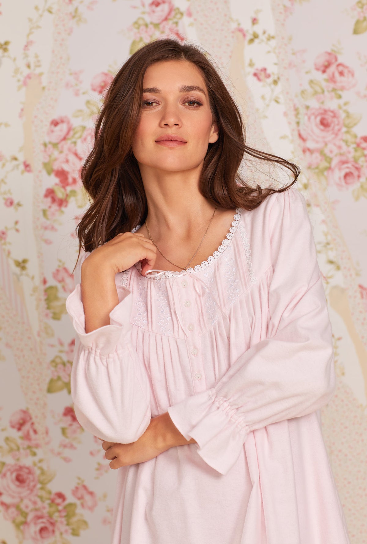 A lady wearing pink long sleeve heritage cotton flannel embroidery waltz nightgown.