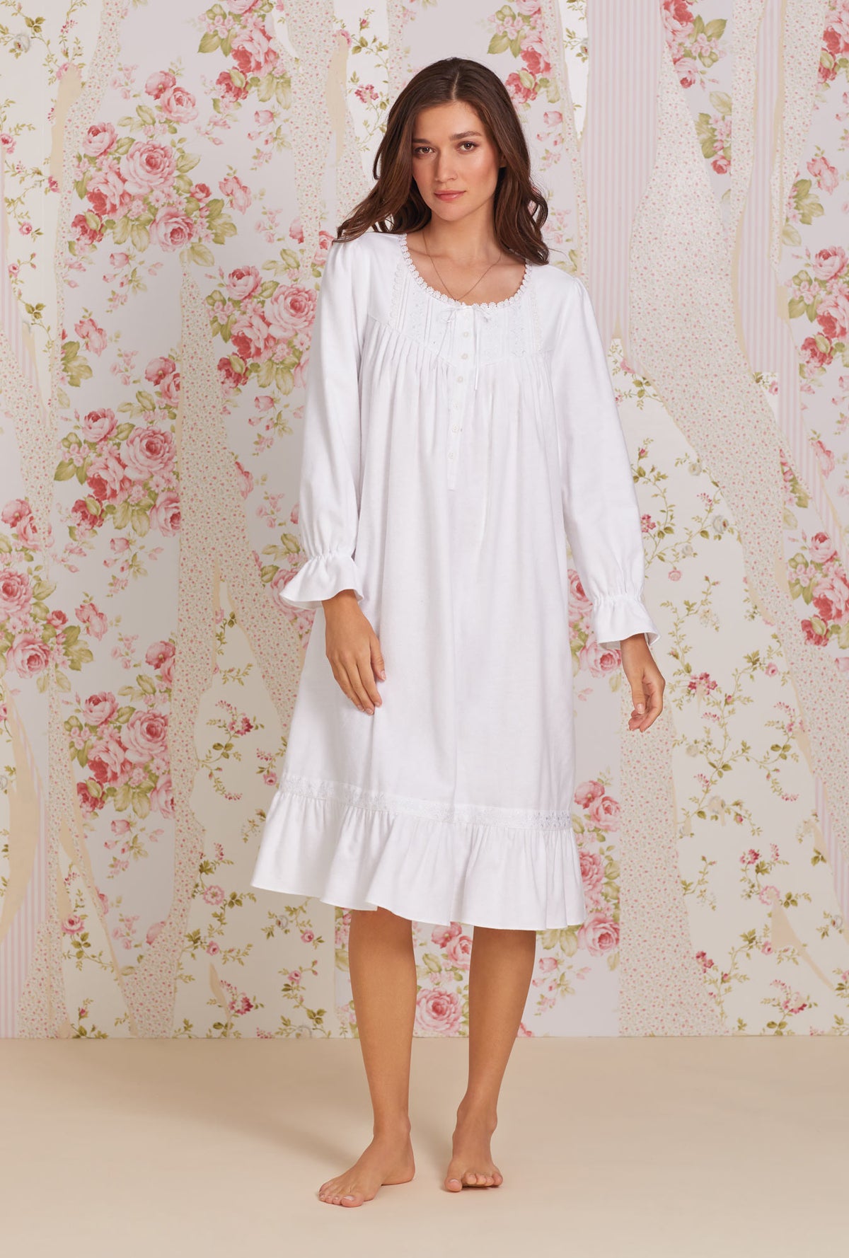 A lady wearing white long sleeve heritage cotton flannel embroidery waltz nightgown.