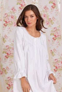 A lady wearing white long sleeve heritage cotton flannel embroidery waltz nightgown.