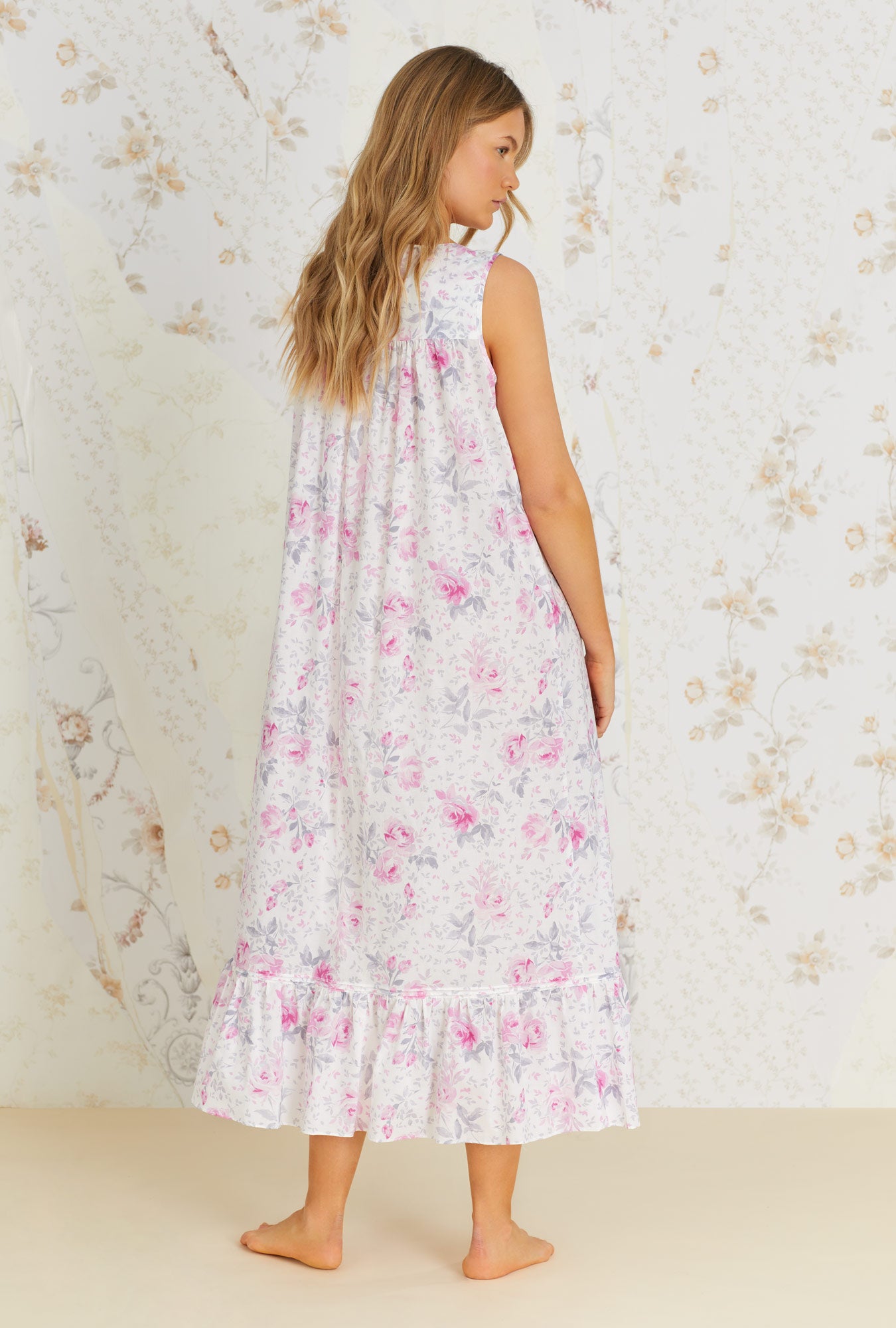 A lady wearing white sleeveless cotton nightgown with mendocino rose print.