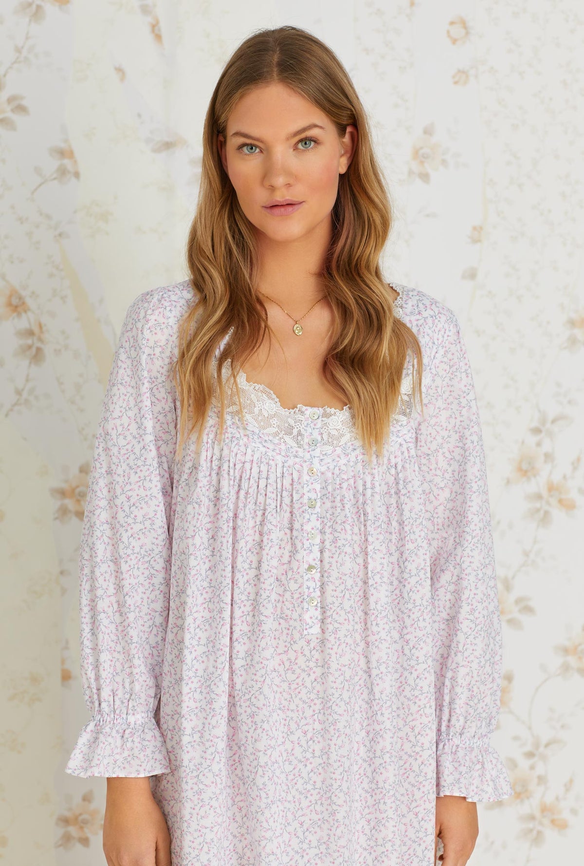 A lady wearing white long sleeve cotton nightgown with baby rosette print.