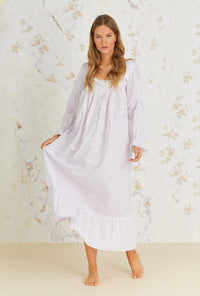 A lady wearing white long sleeve cotton nightgown with baby rosette print.