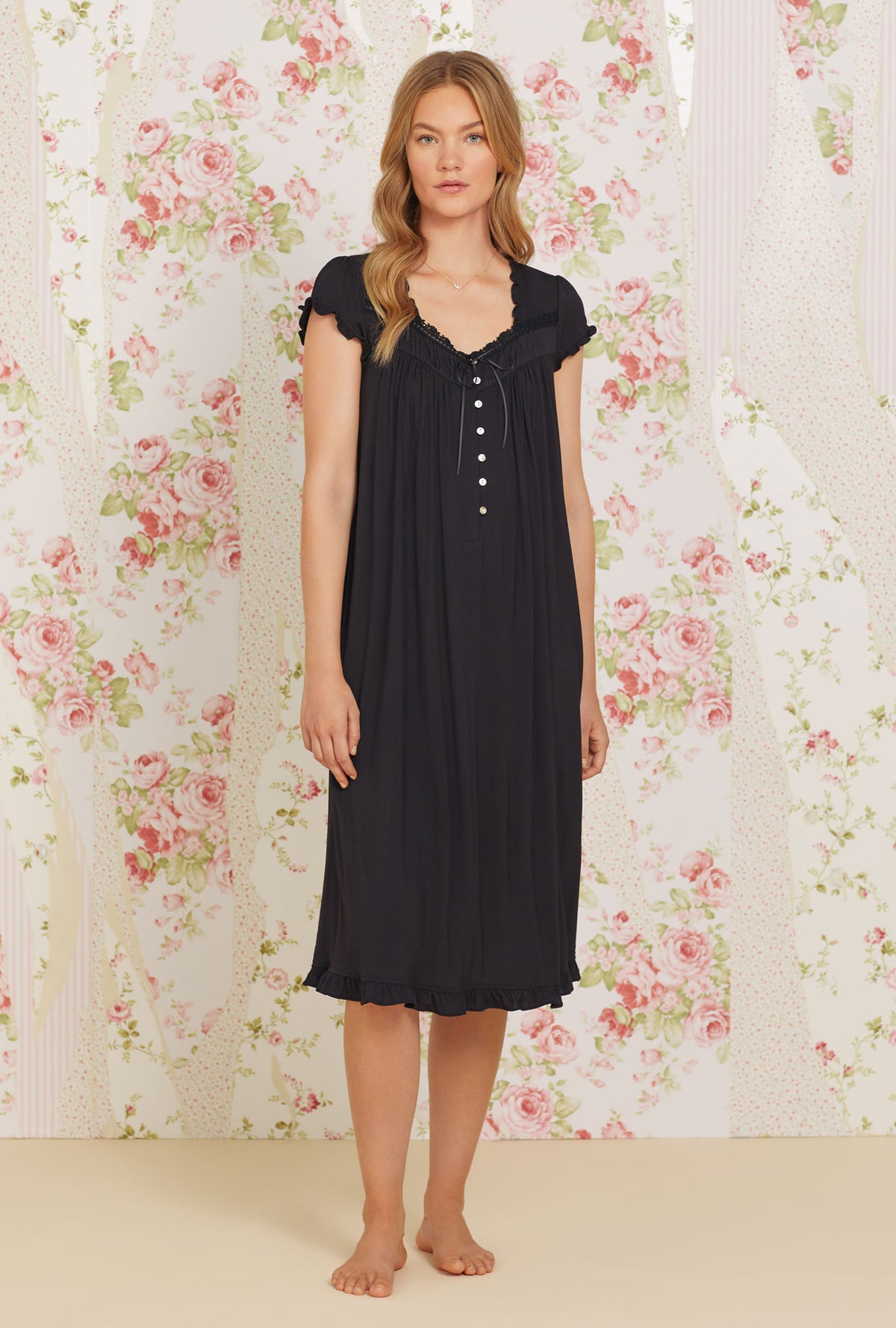 A lady wearing black cap sleeve tencel waltz knit nightgown.