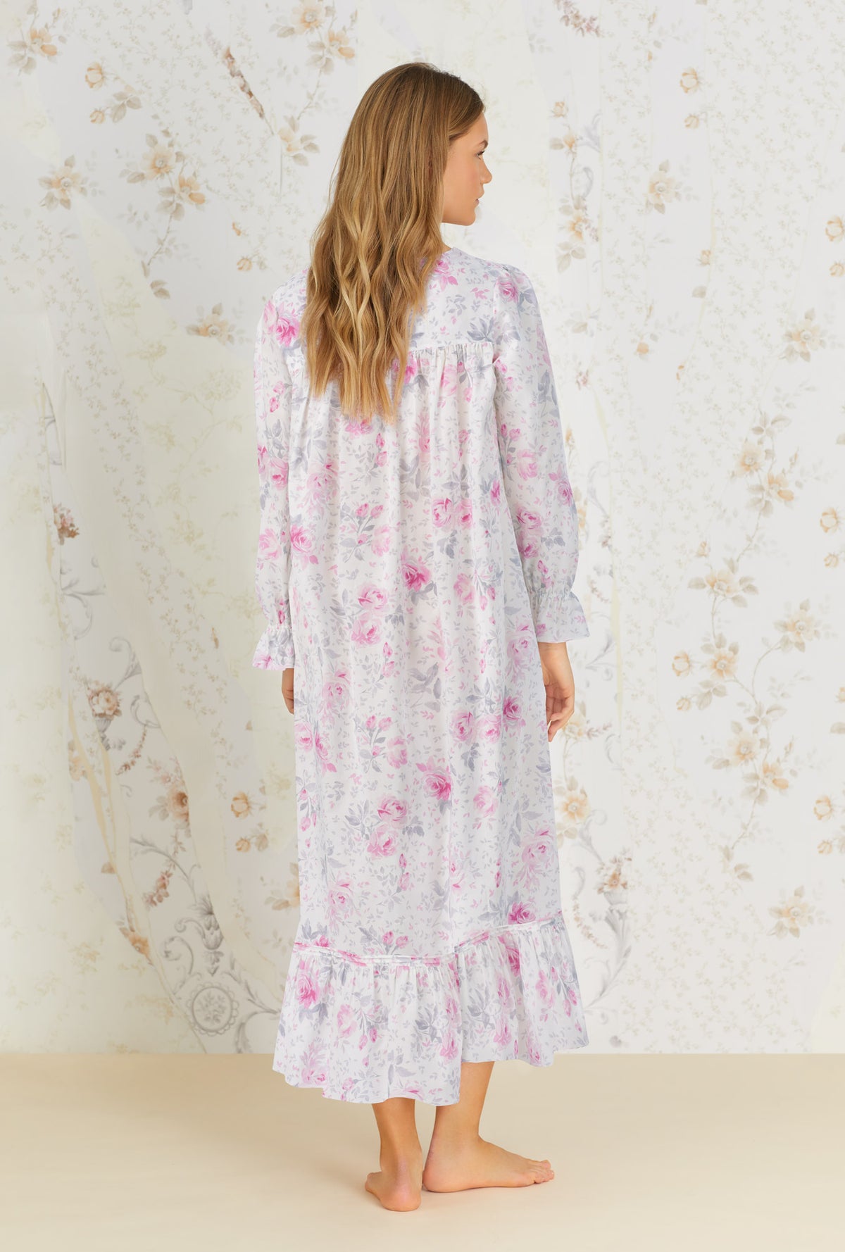 A lady wearing white long sleeve cotton nightgown with mendocino rose print.