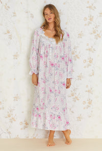 A lady wearing white long sleeve cotton nightgown with mendocino rose print.