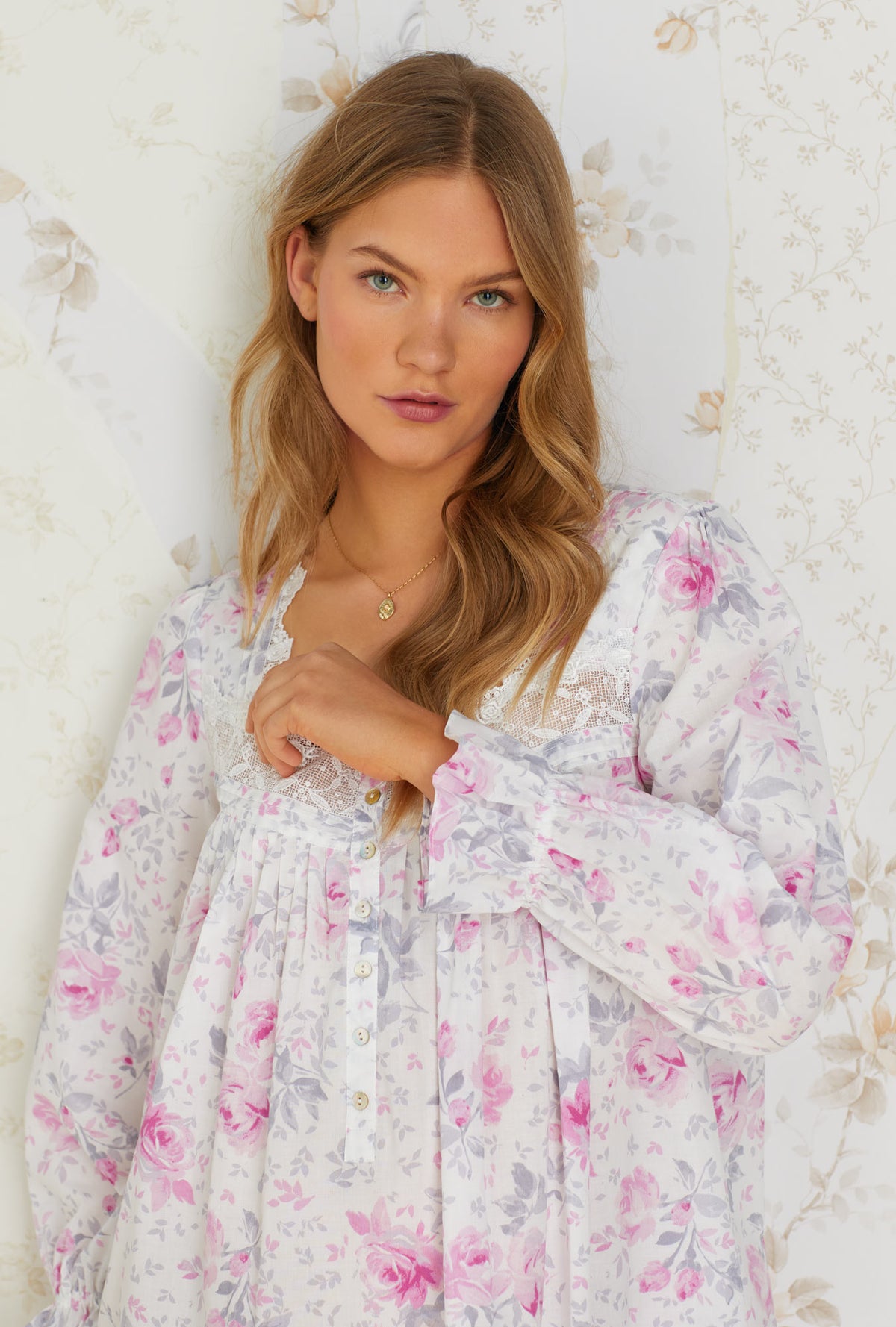 A lady wearing white long sleeve cotton nightgown with mendocino rose print.