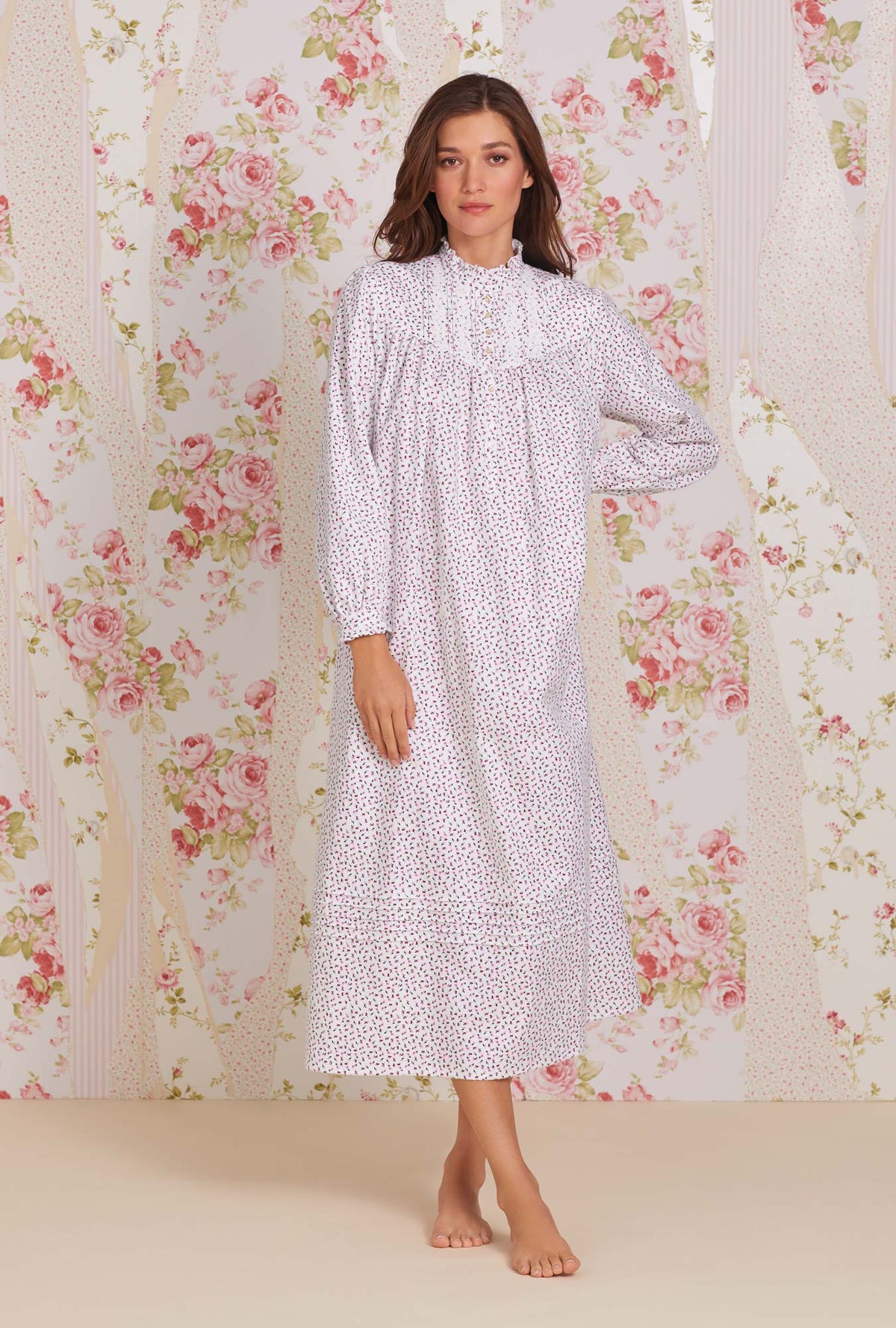 A lady wearing white long sleeve cotton flannel madeline highneck nightgown with joyful berry print.