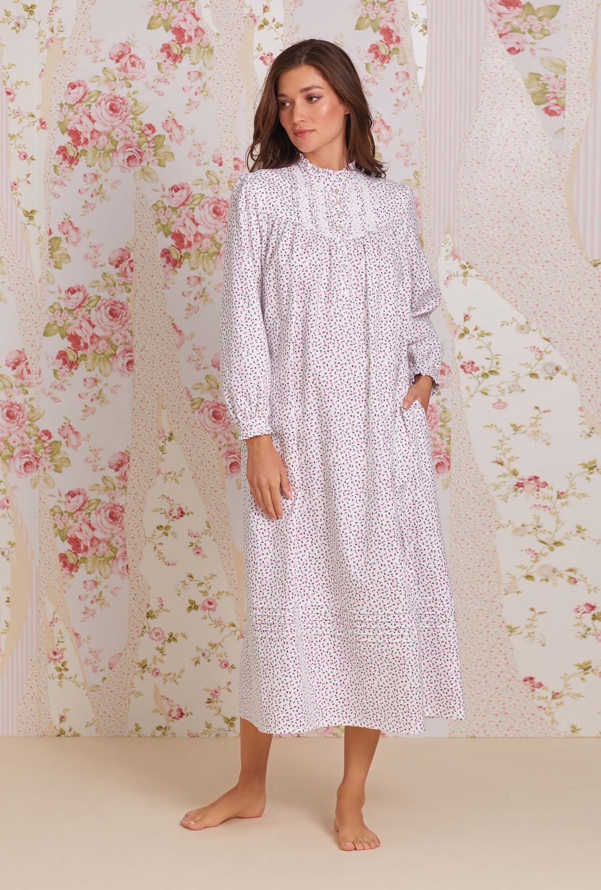 A lady wearing white long sleeve cotton flannel madeline highneck nightgown with joyful berry print.