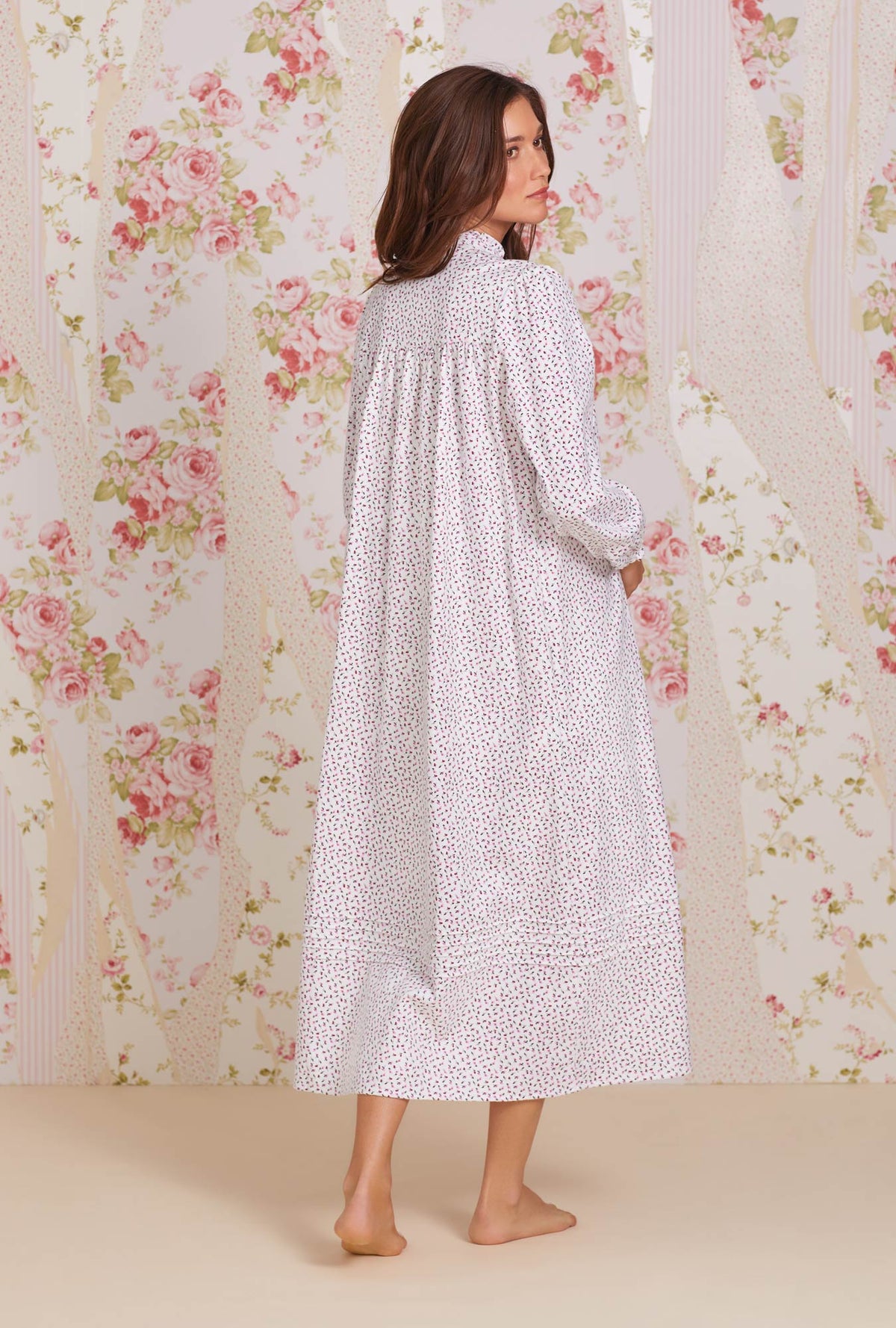 A lady wearing white long sleeve cotton flannel madeline highneck nightgown with joyful berry print.