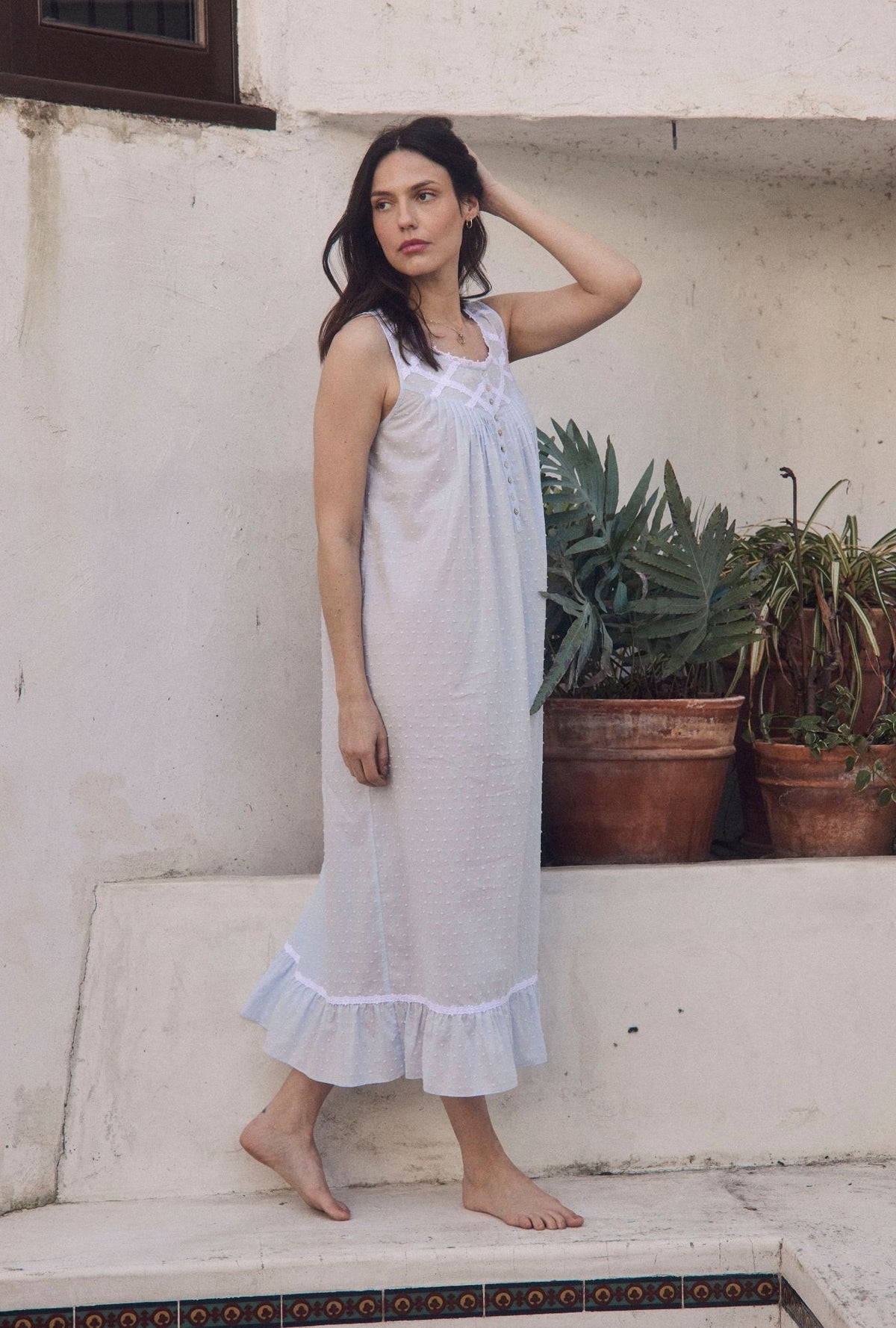 A lady wearing The "Eileen" Sky Blue Cotton Swiss Dot Ballet Nightgown walking outisde