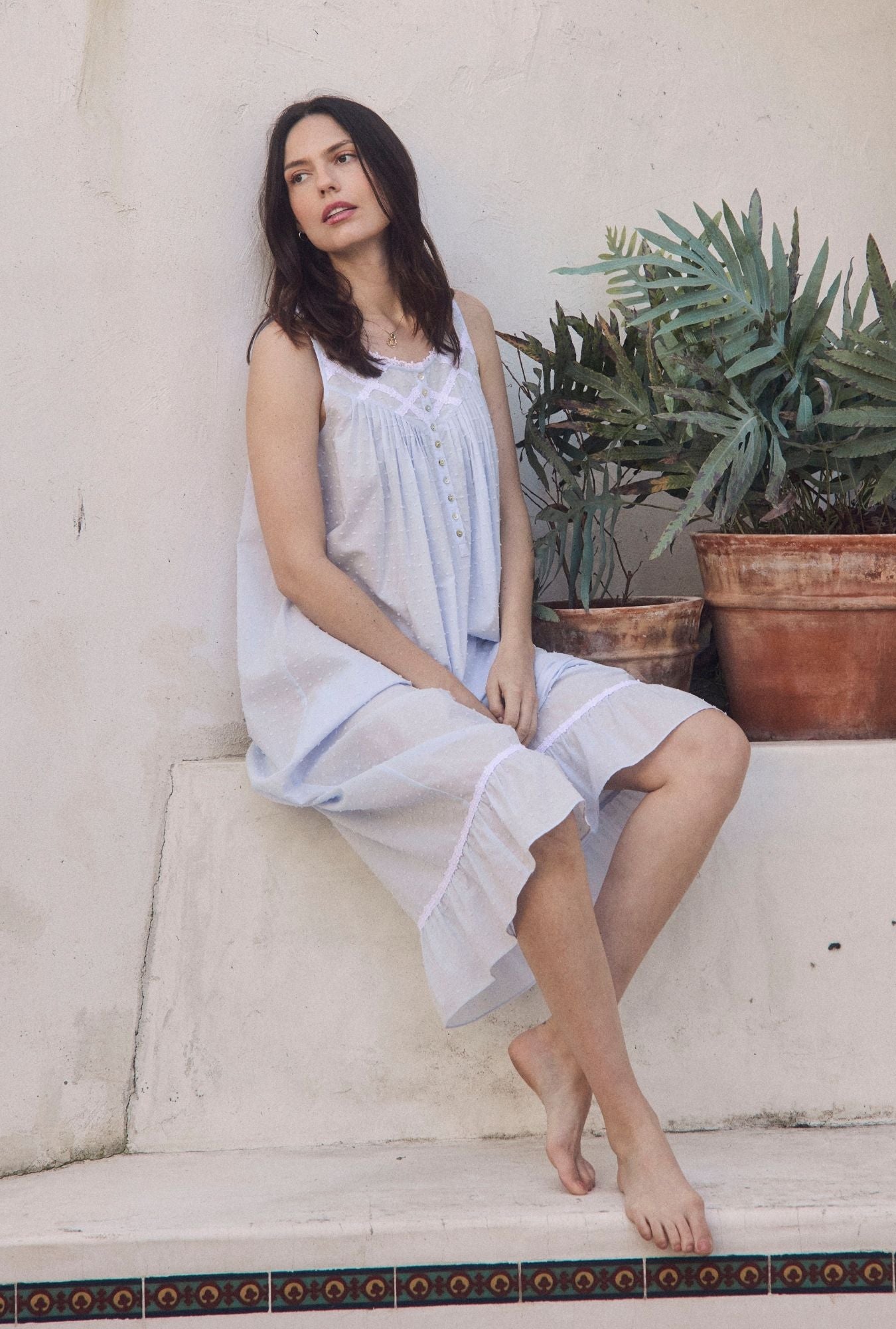 A lady wearing The "Eileen" Sky Blue Cotton Swiss Dot Ballet Nightgown sitting outside