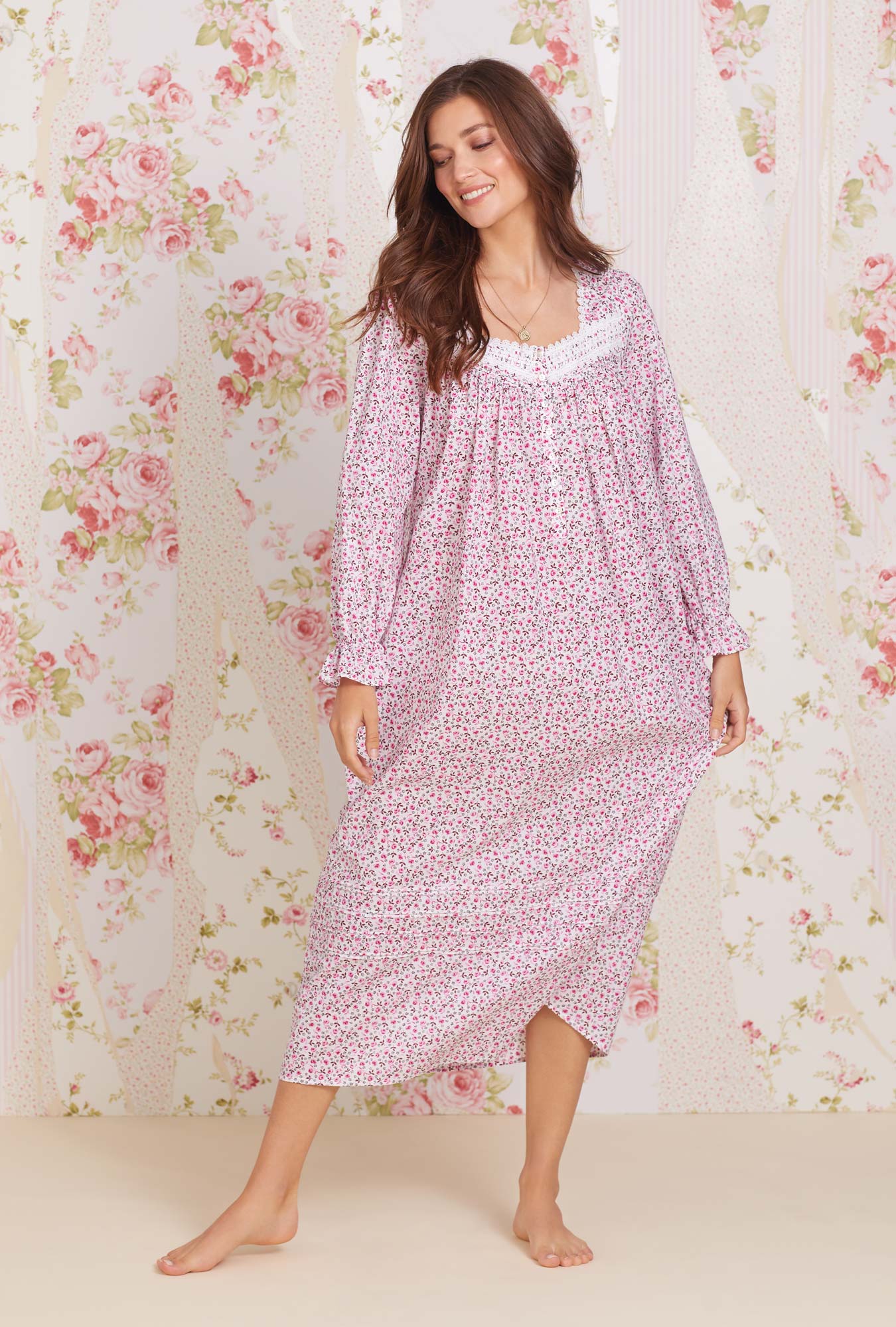 A lady wearing long sleeve eileen cotton lawn nightgown with rose jubilee print.