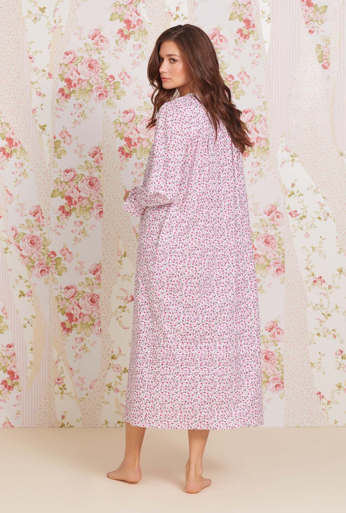A lady wearing long sleeve eileen cotton lawn nightgown with rose jubilee print.