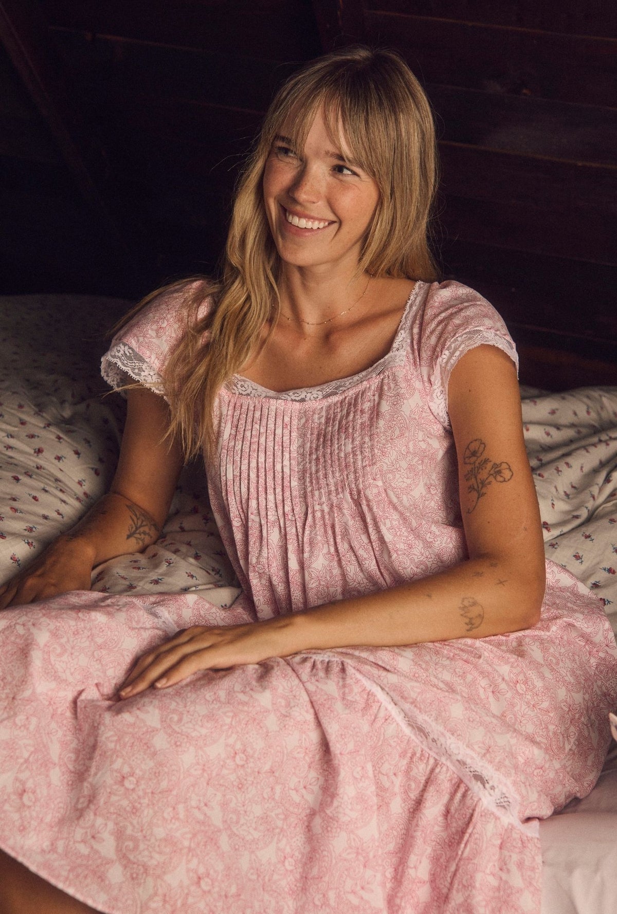 A lady wearing Grace Cameo Garden 100% Cotton Woven Lawn Flutter Sleeve Ballet Nightgown posing front looking sideways with a smile