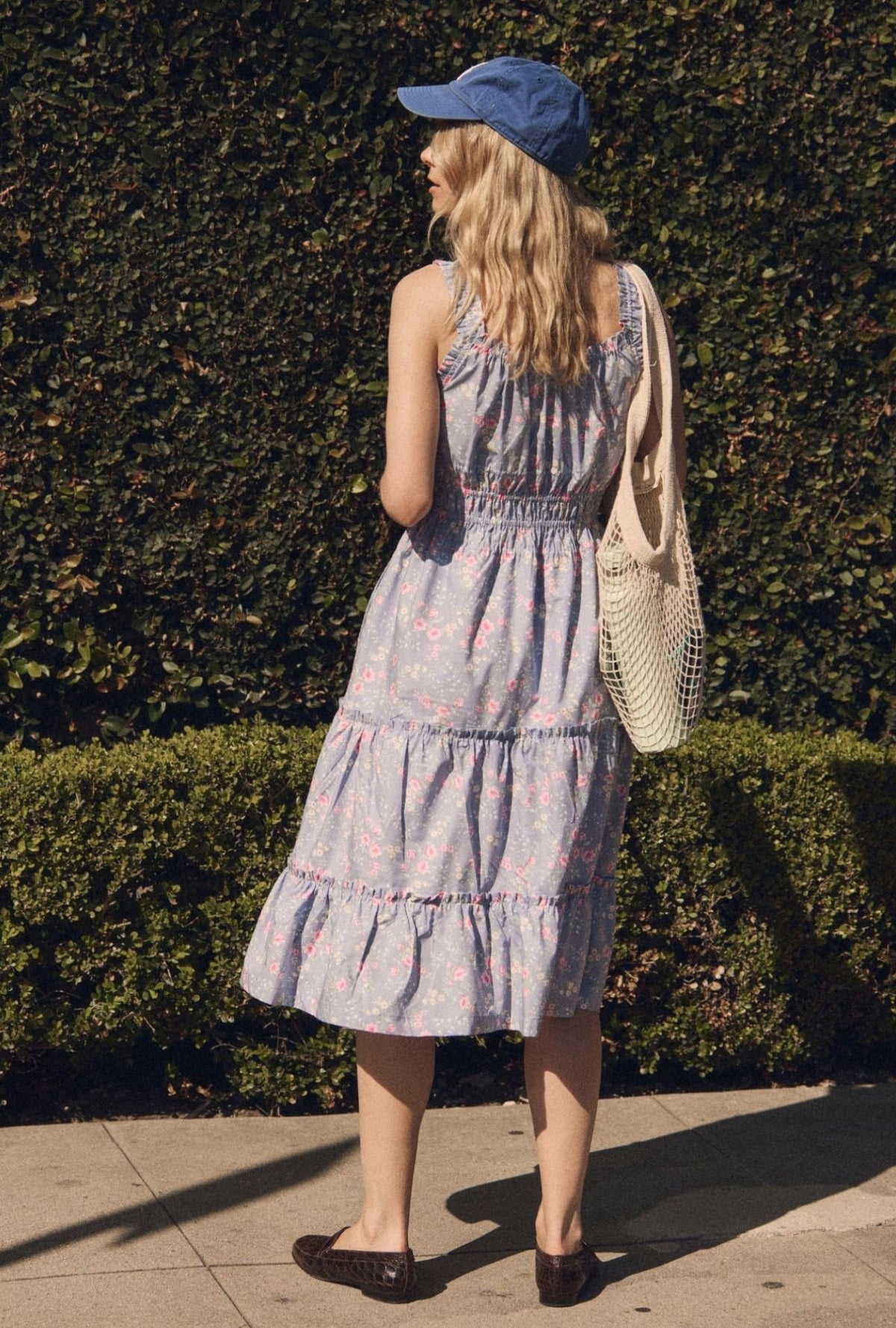 A lady wearing The "Nora" Chambray Rose Cotton Midi Dress back view