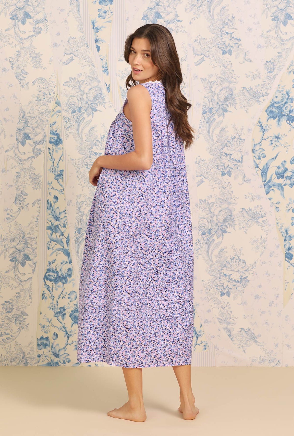 A lady wearing blue sleeveless Eileen&quot; Cotton Nightgown with Joyful Garden print