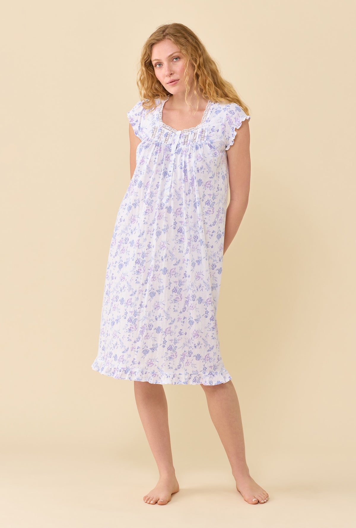 A lady wearing Wildflower Meadow Waltz Nightgown hands behind