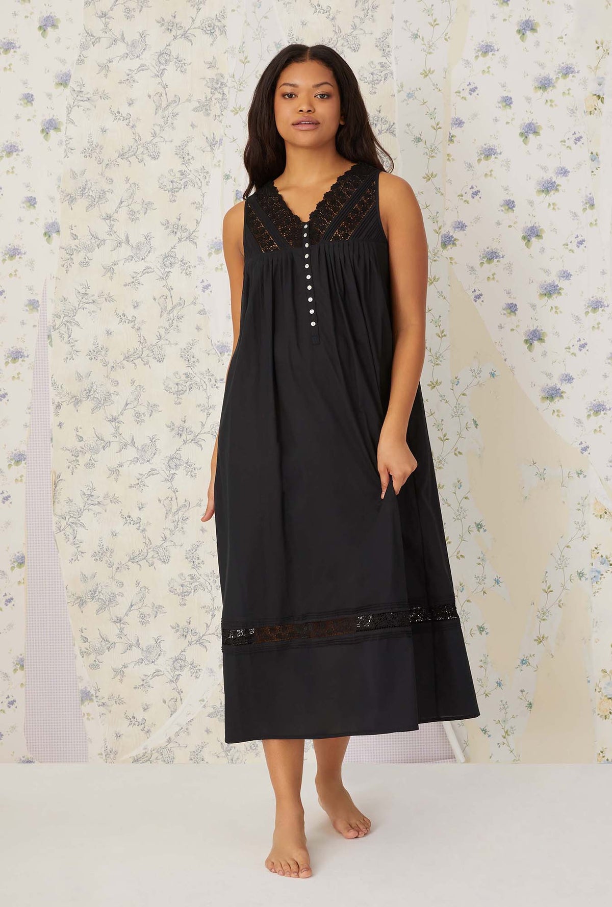 A lady wearing plus size black Portofino Ballet Nightgown in a front face walking pose