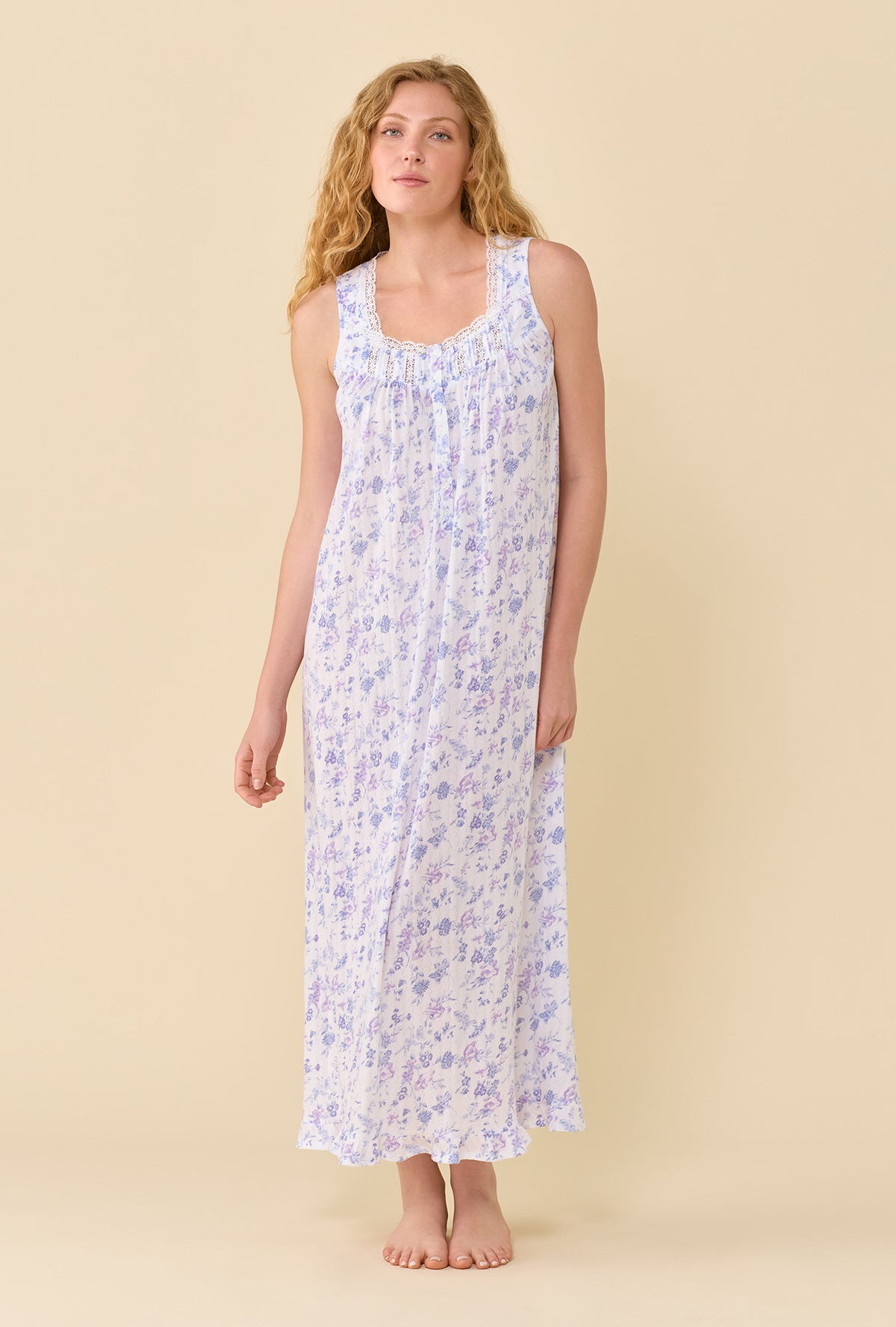 A Lady Wearing The Eileen Wildflower Meadow Nightgown in a front facing pose with a slight natural angle through the torso.