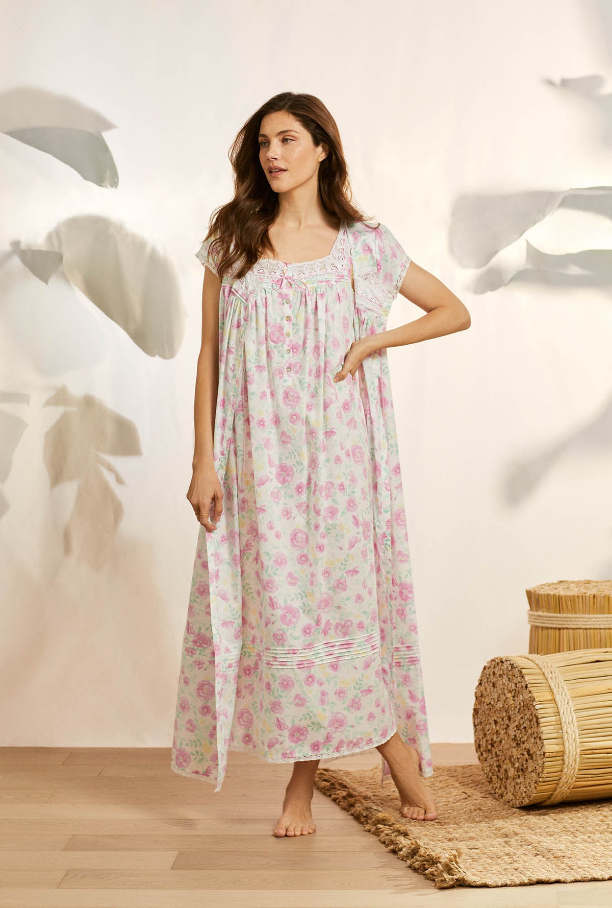 A lady wearing pink sleeveless eileen cotton nightgown with wildflower print.