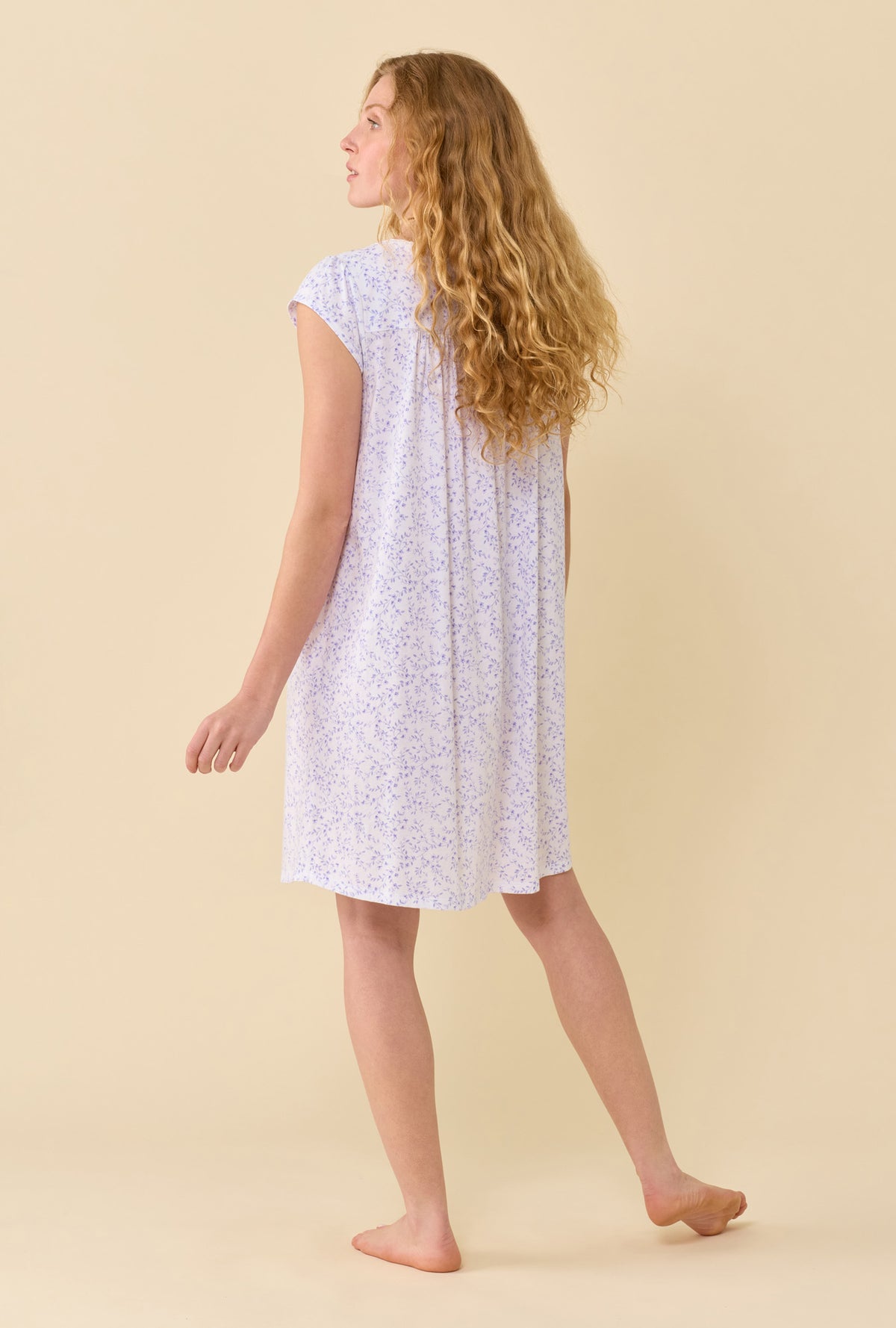 A Lady Wearing Peri Vines Chemise in a back view pose with a side look